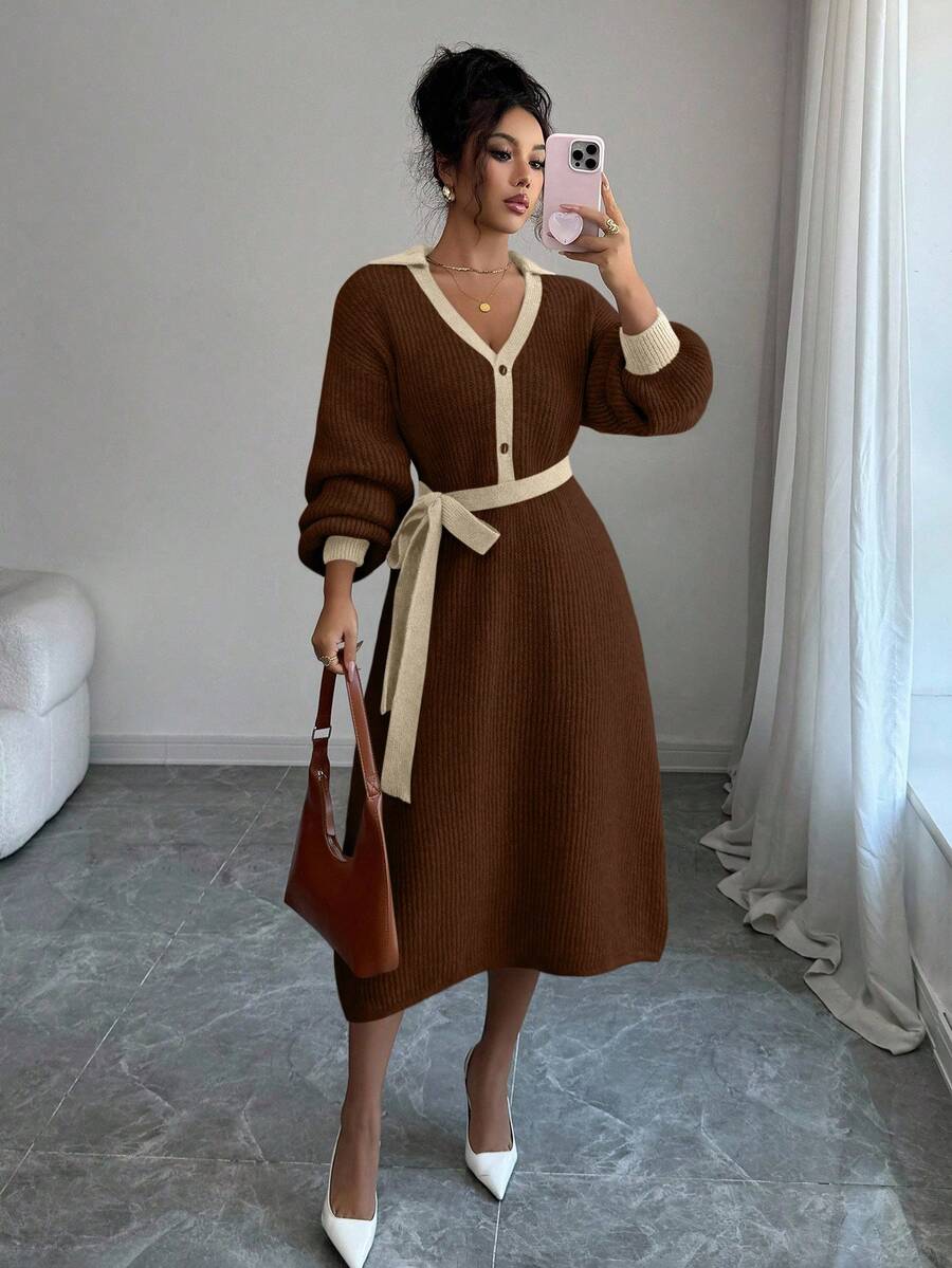 Close view of black and white button-front sweater midi dress with V-shaped polo collar and tied knit belt