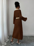 Front view of brown and cream belted polo collar knit midi dress with bishop sleeves and button front