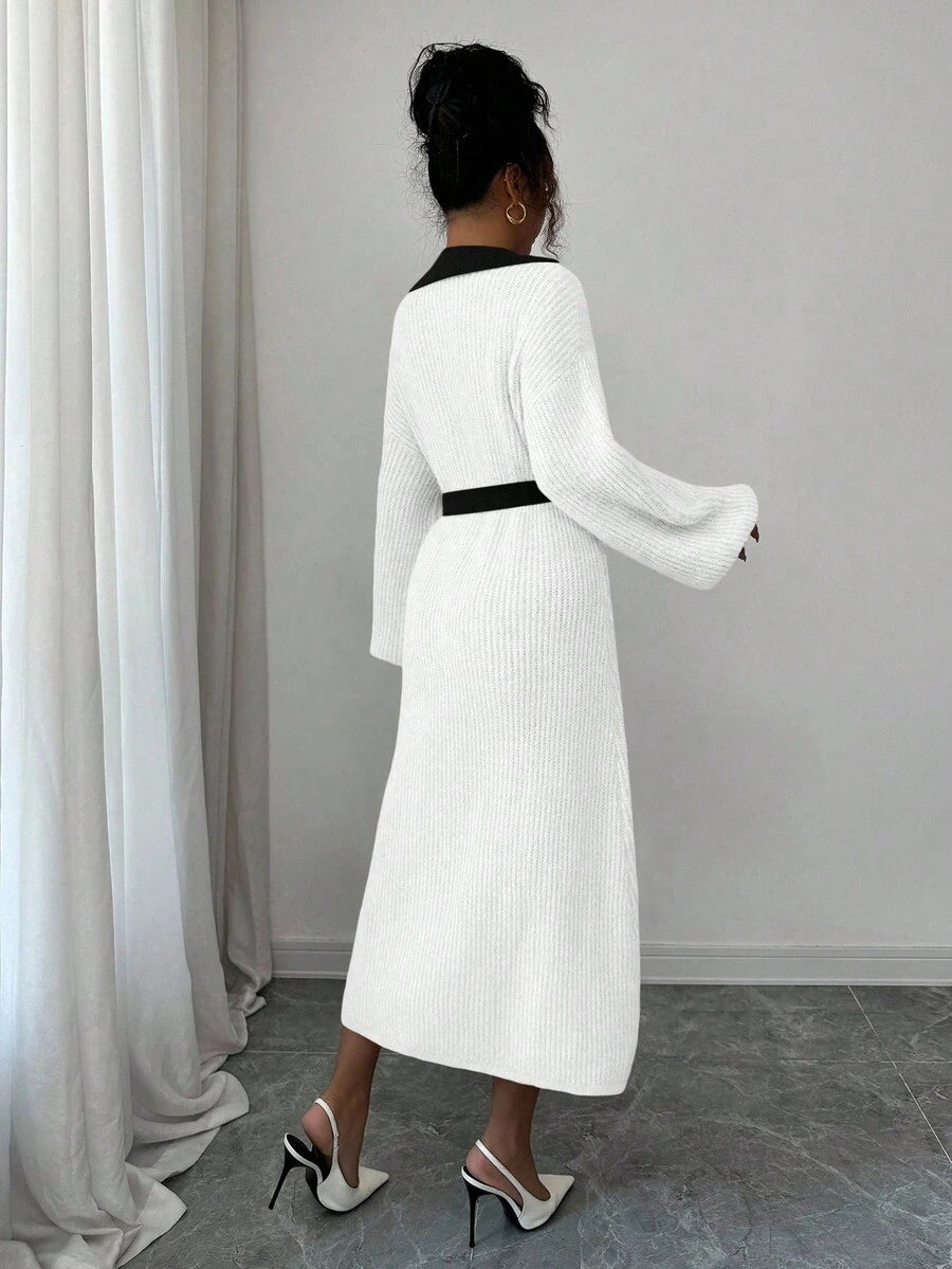 Back view of white and black rib-knit A-line midi dress with high waist and long bishop sleeves