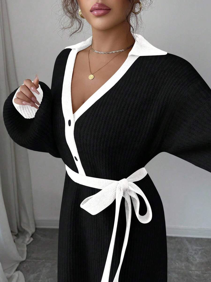 Back view of black and white rib-knit A-line midi dress with high waist and long bishop sleeves