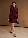 Front view of burgundy rhinestone velvet mini dress with mock neck and tiered ruffle hem