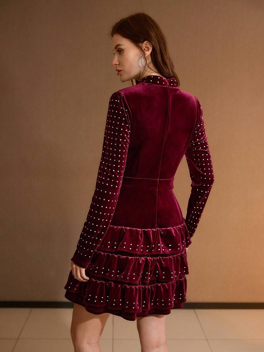 Back three-quarter view of burgundy velvet mini dress with concealed zipper and long sleeves