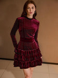 Front three-quarter view of burgundy rhinestone mini dress with fitted waist and ruffle tiers