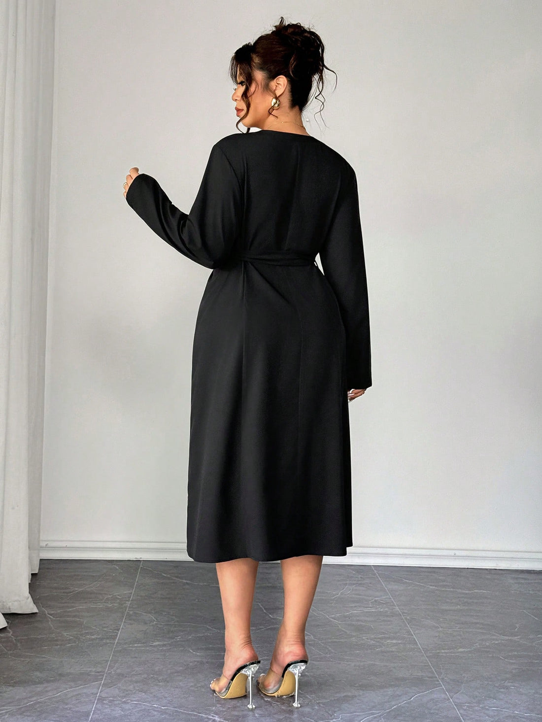 Elevate your wardrobe with this stunning plus-size dress that's equal parts chic and comfortable. The classic black and white palette pairs beautifully with the flattering V-neckline and long sleeves for a polished look that works from office to dinner. The tie waist cinches in all the right places, creating a gorgeous silhouette while the elegant design keeps you feeling confident and fabulous. Perfect for anyone who refuses to compromise on style or fit.