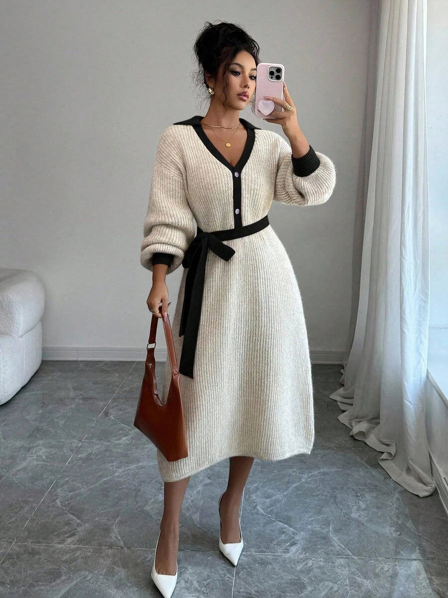 Front view of cream and black belted polo collar knit midi dress with bishop sleeves and button front