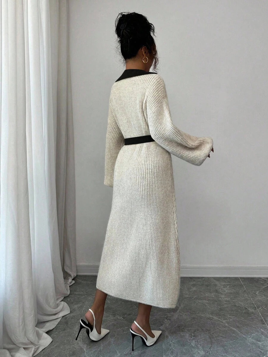 Back view of cream and black rib-knit A-line midi dress with high waist and long bishop sleeves