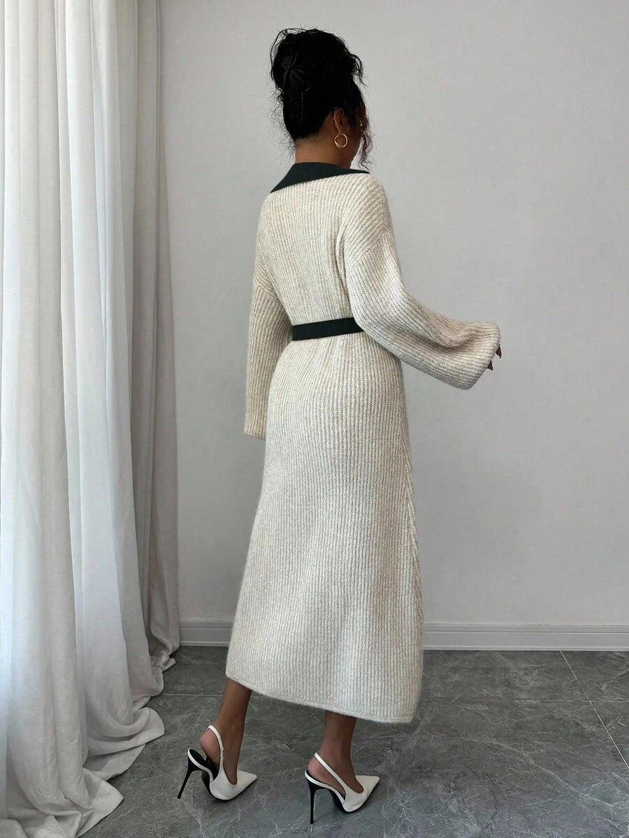 Back view of cream and navy rib-knit A-line midi dress with high waist and long bishop sleeves