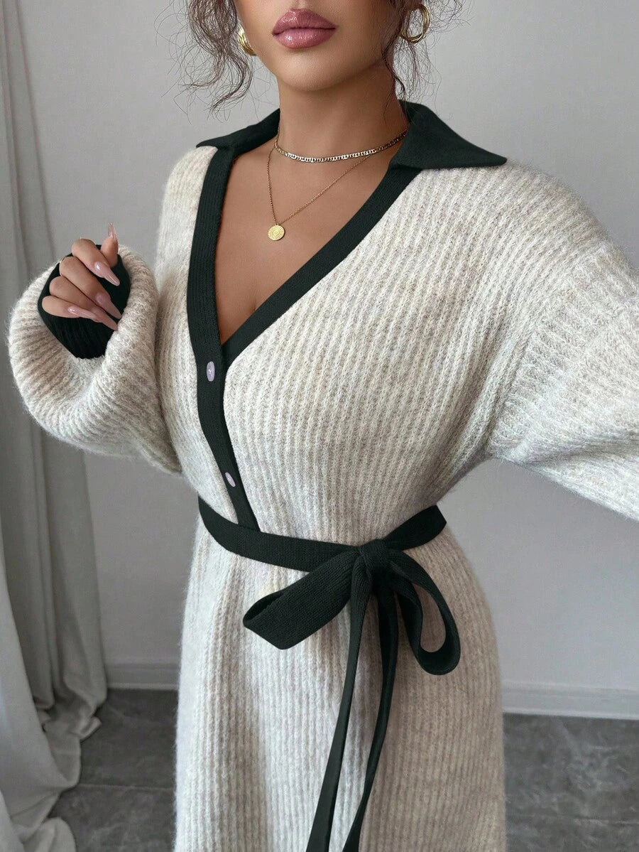 Close view of cream and navy button-front sweater midi dress with V-shaped polo collar and tied knit belt