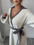 Back view of cream and grey rib-knit A-line midi dress with high waist and long bishop sleeves