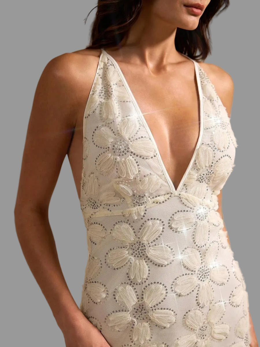 Make a statement in this stunning backless evening dress featuring intricate 3D sequin floral embellishments. The deep V-neckline and sleeveless silhouette create an alluring, sophisticated look, while the high-waisted fitted design flatters your figure. Crafted from quality woven polyester with a lined interior, this apricot gown transitions beautifully from beach gatherings to weddings and night-out occasions. The all-over floral print adds elegant dimension and visual interest. Perfect for those seeking 