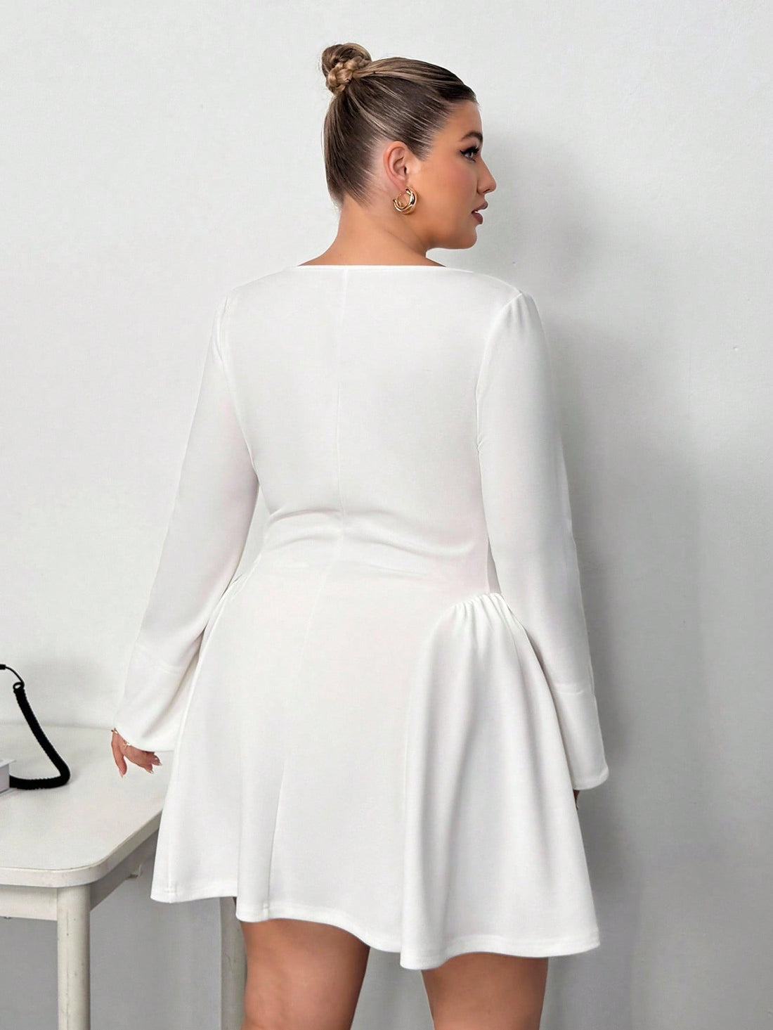 Elevate your cold-weather wardrobe with this fabulous plus-size mini dress that proves you don't have to choose between comfort and style. The long sleeves keep you cozy while the cinched waist creates a flattering silhouette that celebrates your curves. Perfect for autumn and winter outings, this chic piece transitions effortlessly from casual coffee dates to evening adventures. The mini length adds a flirty touch that's undeniably fun and fashion-forward. Dress it up with boots and jewelry or keep it rela