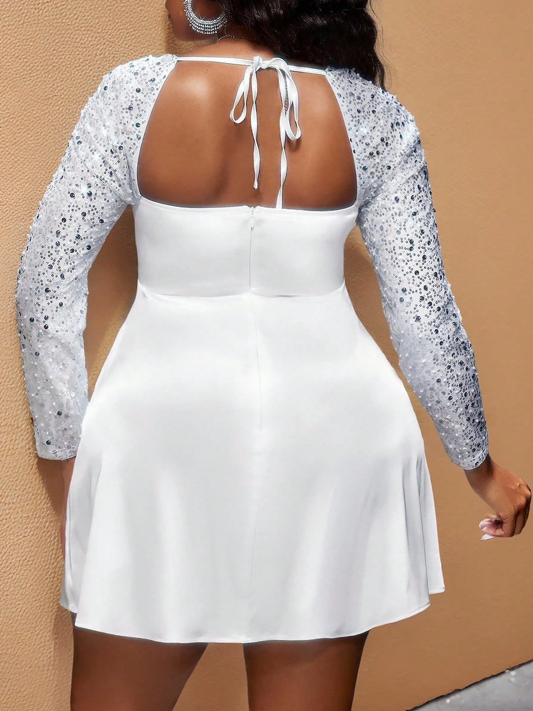 Celebrate your curves with this stunning plus-size mini dress designed to flatter pear-shaped figures! The strategic waist-cinching creates an hourglass silhouette while the sheer sequin patchwork adds glamorous sparkle exactly where you want it. Crafted from luxurious satin, this dress hugs your best features and lets you shine at any occasion. Whether you're heading to a night out or a special event, this playful piece proves that style has no size limit. Turn heads and feel fabulous!