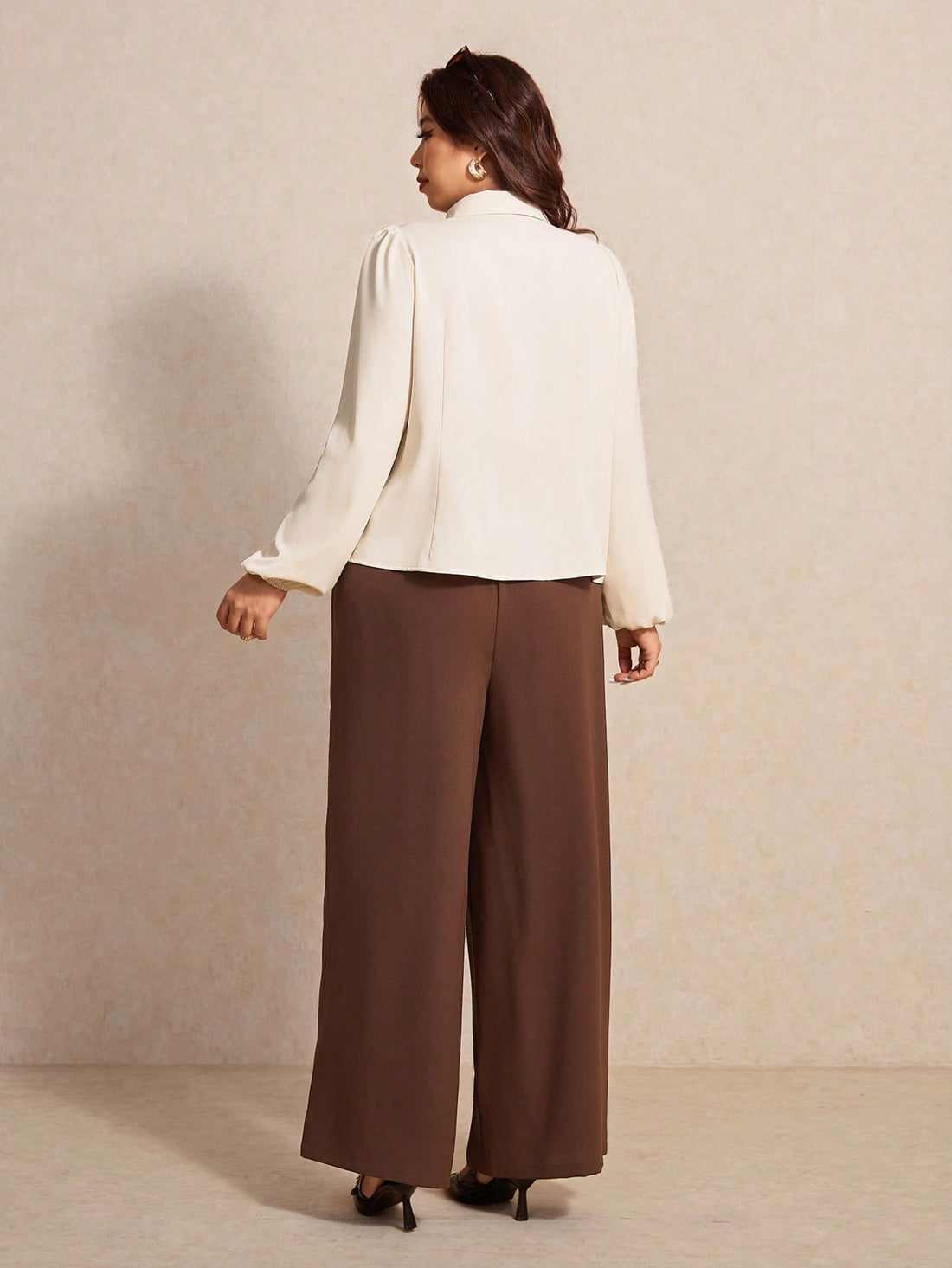 Elevate your wardrobe with this fabulous two-piece set designed for the modern woman who loves to make a statement. The long-sleeve shirt features charming bow details that add a touch of sophistication, while the flowing wide-leg pants offer comfort without compromising style. Perfect for dressing up or down, this ensemble celebrates your curves with flattering silhouettes that move with you. Whether you're heading to brunch, the office, or a night out, you'll feel confident and chic in this versatile set 