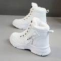 Rear three-quarter view of white PU leather ankle boots with pull tabs and lug soles
