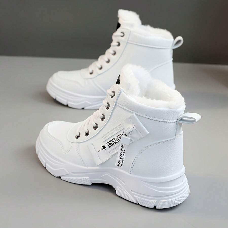 Rear three-quarter view of white PU leather ankle boots with pull tabs and lug soles