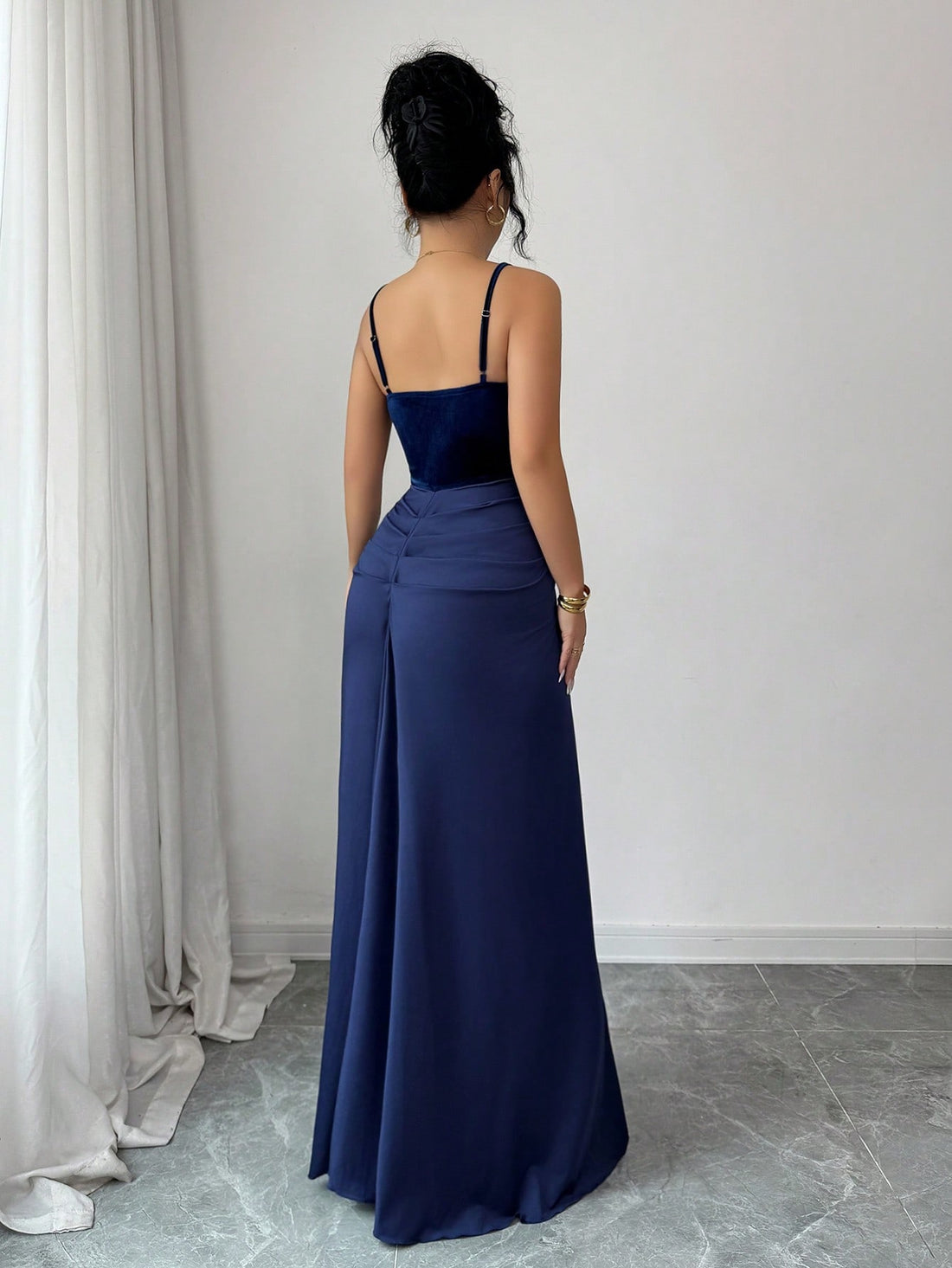 Slip into pure sophistication with this stunning velvet maxi dress that's ready to turn heads at your next event. The fitted silhouette hugs your curves in all the right ways, while luxurious velvet fabric adds an irresistible touch of glamour. Adjustable spaghetti straps ensure a custom fit that feels as good as it looks, letting you move with confidence from cocktail hour through the dance floor. Whether you're celebrating a special milestone or making a grand entrance, this dress delivers elegance with a