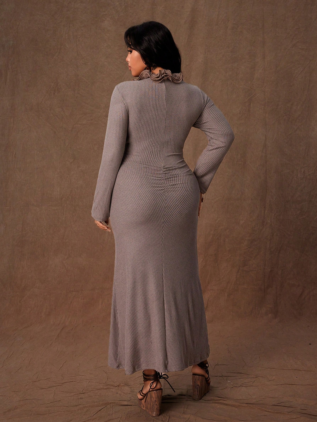 Embrace your curves in this stunning ribbed knit bodycon dress that's equal parts sass and sophistication. The fitted silhouette hugs you in all the right places, while delicate ruffle detailing at the hem adds a flirty touch. A cheeky slit keeps things interesting and lets you move with confidence. Perfect for autumn evenings when you want to turn heads without trying too hard. Available in rich, versatile solid colors that complement every skin tone. This is the dress that makes you feel like the best ver