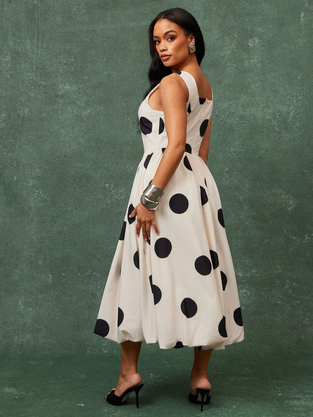 Turn heads with this charming polka dot midi dress that effortlessly blends vintage-inspired style with modern flair. The voluminous puff sleeves add a playful touch, while the bubble hem creates a fun, dimensional silhouette that moves beautifully. Perfect for brunch dates, garden parties, or any occasion where you want to make a statement. Dress it up with heels or keep it casual with sneakers—this versatile piece adapts to your mood and makes getting dressed an absolute joy.