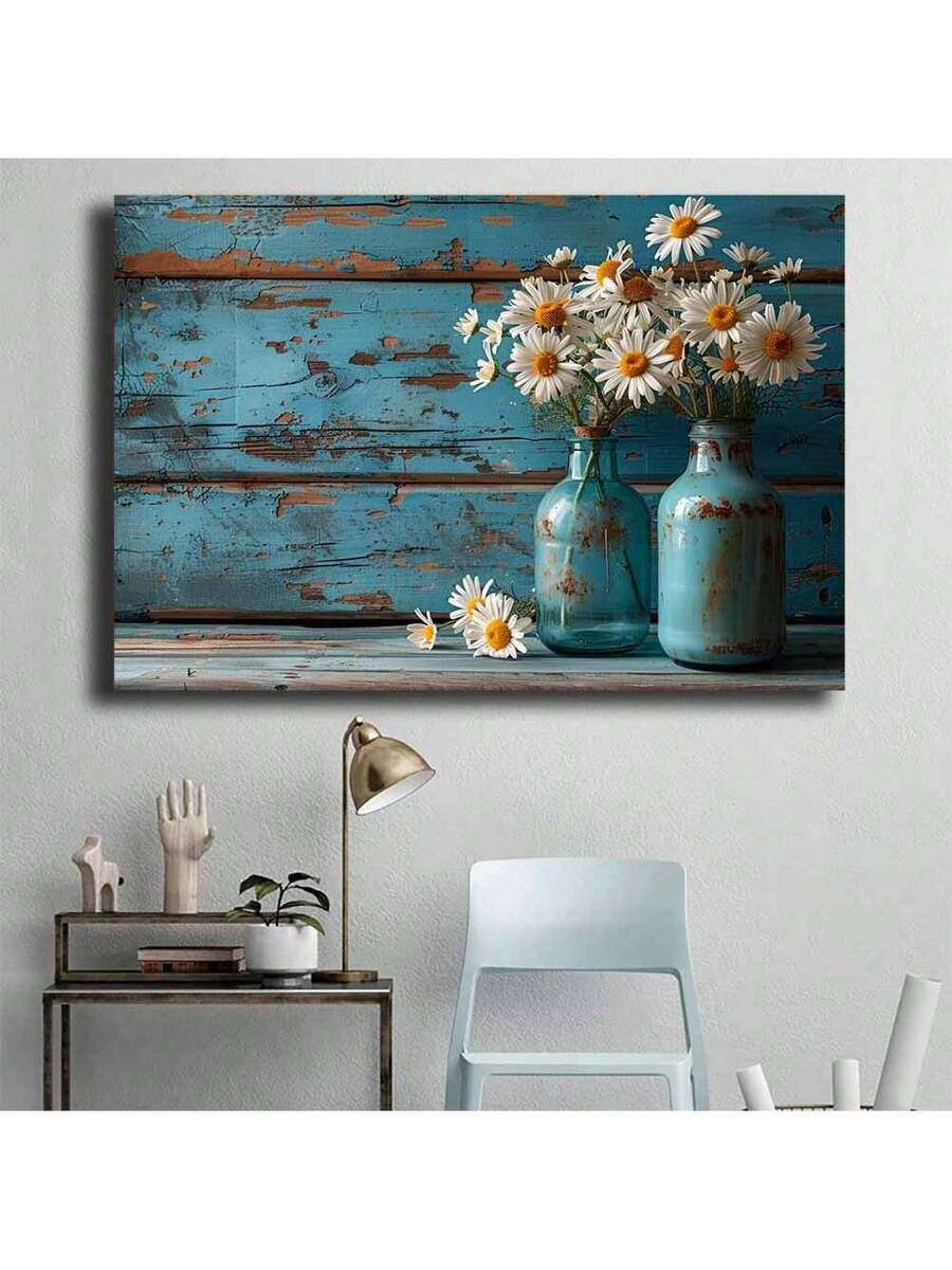 Desk corner view of white flower wall art with blue jars and distressed wood