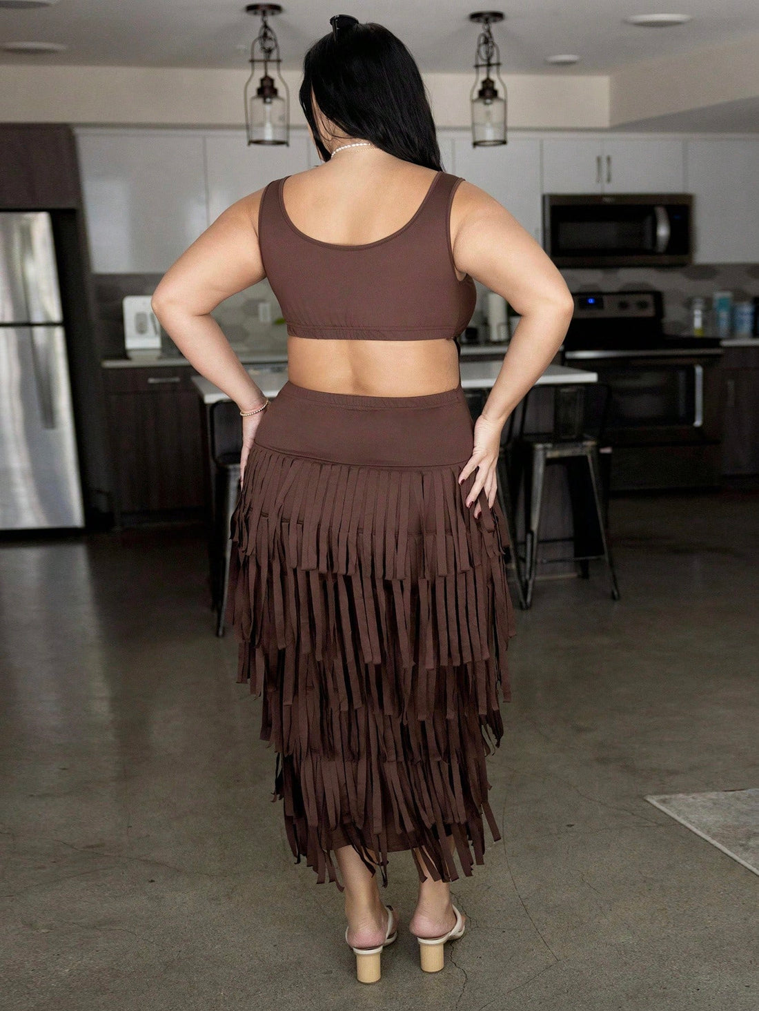 Slip into effortless elegance with this stunning brown maxi dress, thoughtfully designed to celebrate pear-shaped curves. The flowing silhouette skims your figure while the playful tassel details add movement and personality. Whether you're lounging by the pool, dancing at a festival, or turning heads at a summer soirée, this versatile piece transitions seamlessly from day to night. The rich brown tone pairs beautifully with everything in your wardrobe, making it the ultimate vacation essential. Comfort mee