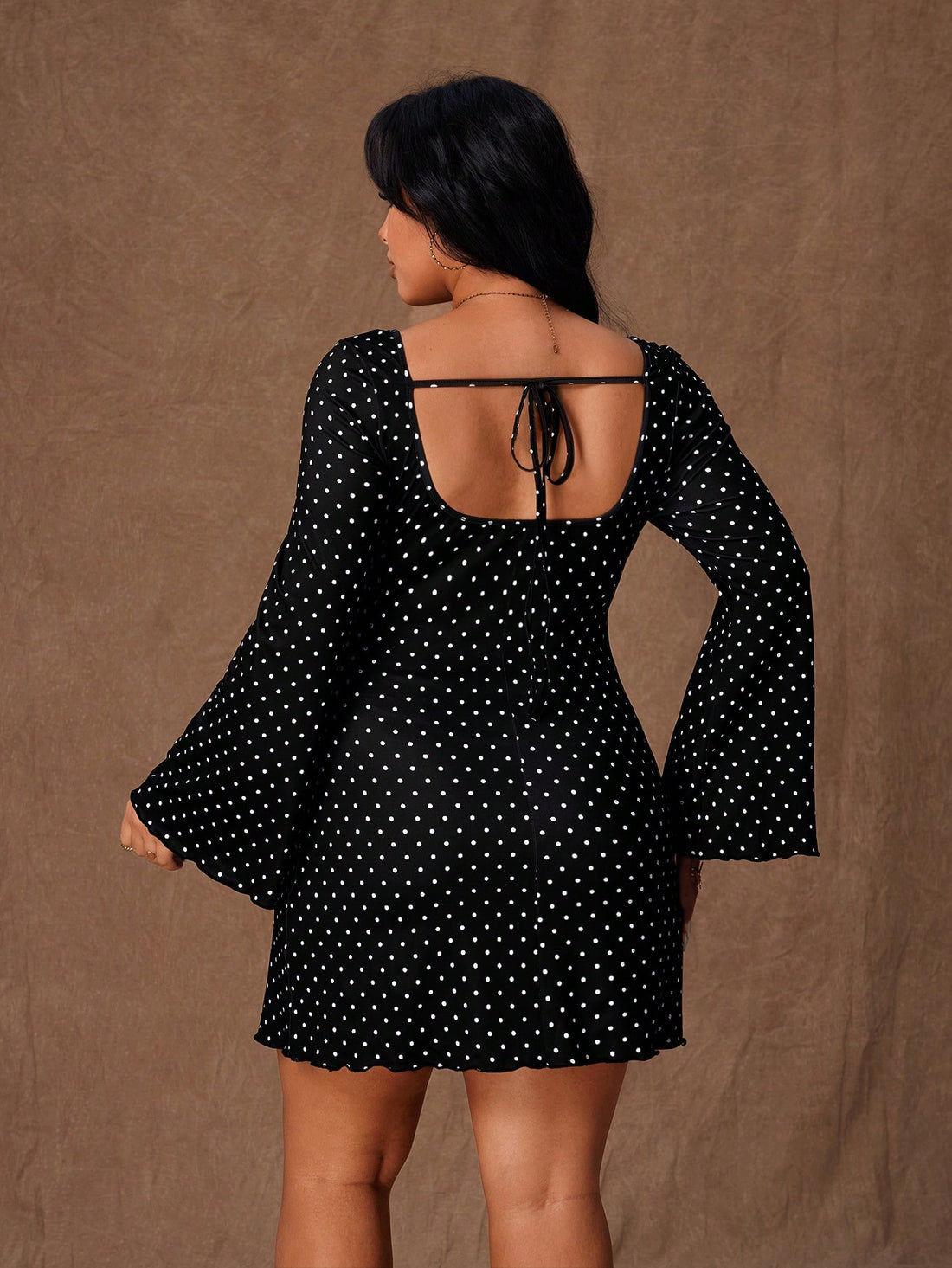 Turn heads at your next autumn soirée in this stunning black polka dot bodycon mini dress. The flare sleeves add a romantic flair while the daring backless design keeps things sultry and sophisticated. Perfectly tailored for plus-size figures, this dress hugs your curves in all the right ways, making you feel confident and fabulous. Whether you're dancing the night away or enjoying intimate gatherings, this playful yet elegant piece is your go-to for making a memorable entrance.