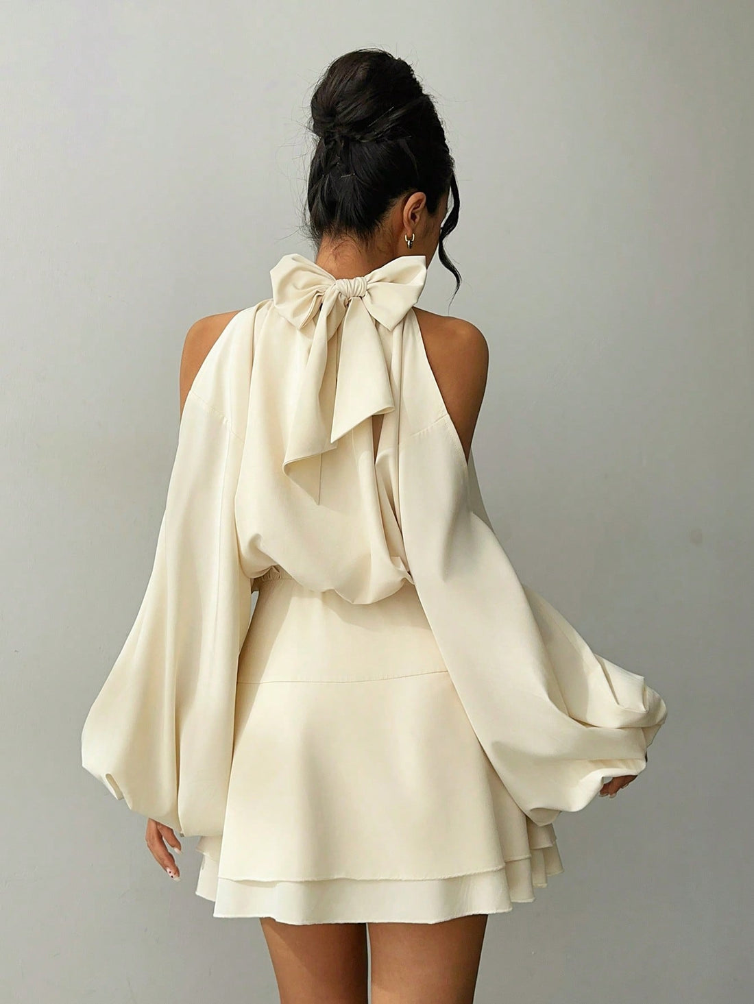 Slip into effortless elegance with this apricot mini dress that's ready to turn heads at your next gathering. The dramatic long lantern sleeves add a touch of whimsy and sophistication, while the flattering silhouette keeps things chic and modern. Whether you're heading to a cozy autumn party or a winter date night, this versatile piece transitions seamlessly from season to season. The warm apricot hue complements all skin tones and pairs beautifully with your favorite boots or heels. A playful yet polished