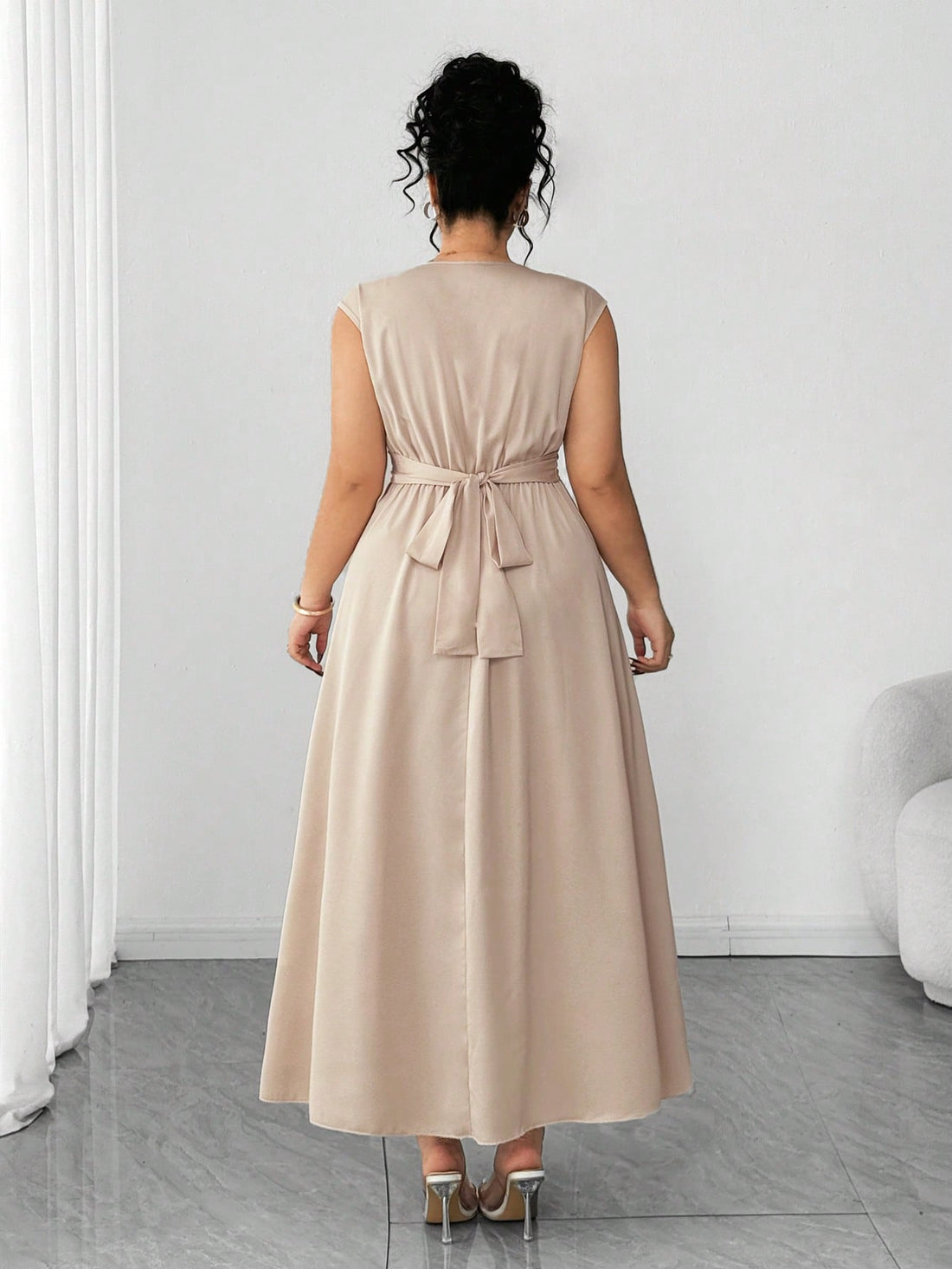 Slip into effortless sophistication with this stunning plus-size dress that celebrates curves in all the right ways. The dramatic batwing sleeves add a touch of flair while the flattering V-neckline draws the eye upward. The criss-cross waist design cinches beautifully, creating a gorgeous silhouette that's both comfortable and chic. Whether you're heading to brunch, a night out, or anywhere in between, this versatile piece proves that elegance has no size limit. Dress it up with heels or keep it casual—you
