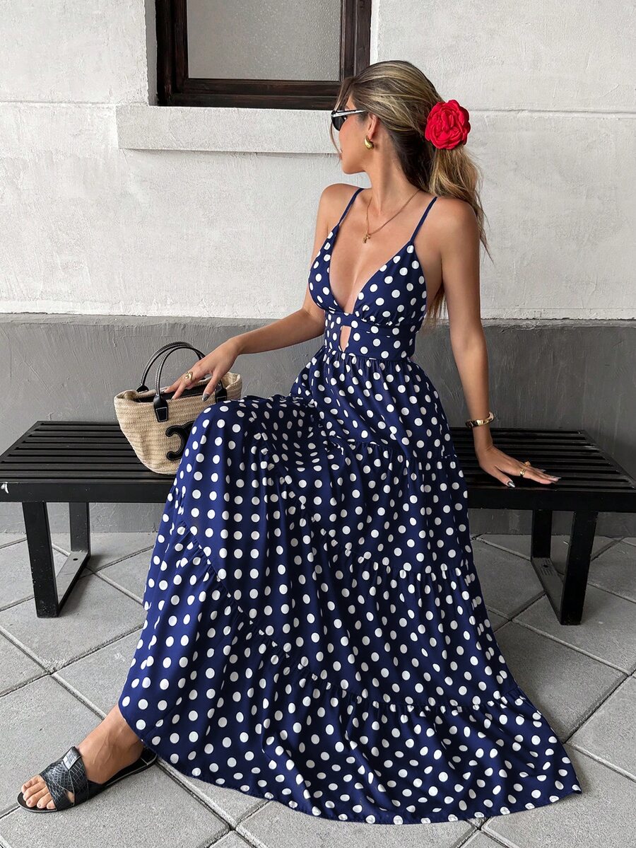 Navy blue and white polka dot backless tiered maxi dress, seated front view