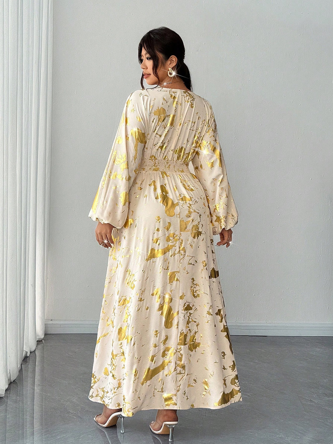 Elevate your wardrobe with this stunning plus-size maxi dress that's pure gold—literally! The shimmering gold foil detailing catches the light beautifully, while the flattering V-neckline draws the eye upward. Perfect for spring getaways and autumn adventures, this resort-ready piece transitions seamlessly from beachside brunches to evening soirées. The flowing maxi silhouette skims your curves in all the right ways, offering comfort without compromising on style. Whether you're lounging poolside or explori