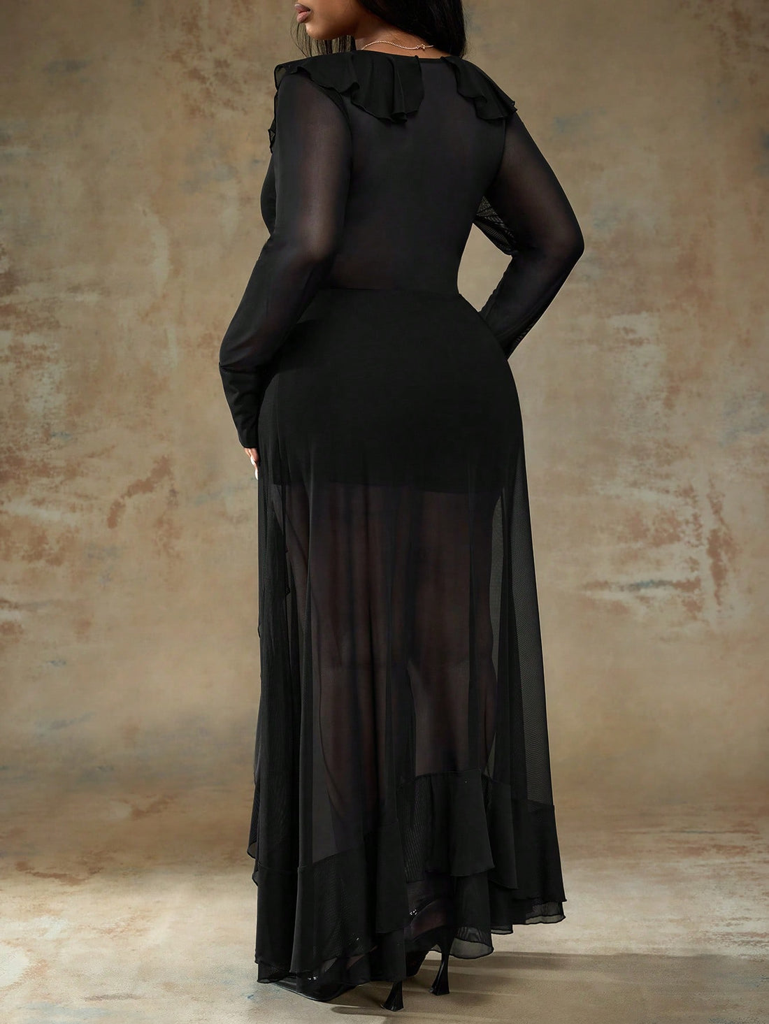 Turn heads at your next night out in this stunning plus-size dress that perfectly blends sass and sophistication. The sheer black fabric creates an alluring silhouette, while delicate lace-up detailing adds an edgy touch of intrigue. A flirty ruffle hem keeps things playful and fun, giving you movement with every step. Whether you're hitting the dance floor or enjoying an intimate dinner date, this dress delivers confidence and style in all the right ways. Designed for curves, crafted for compliments.