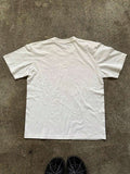 Back flat lay of plain white short-sleeve crew-neck T-shirt on concrete