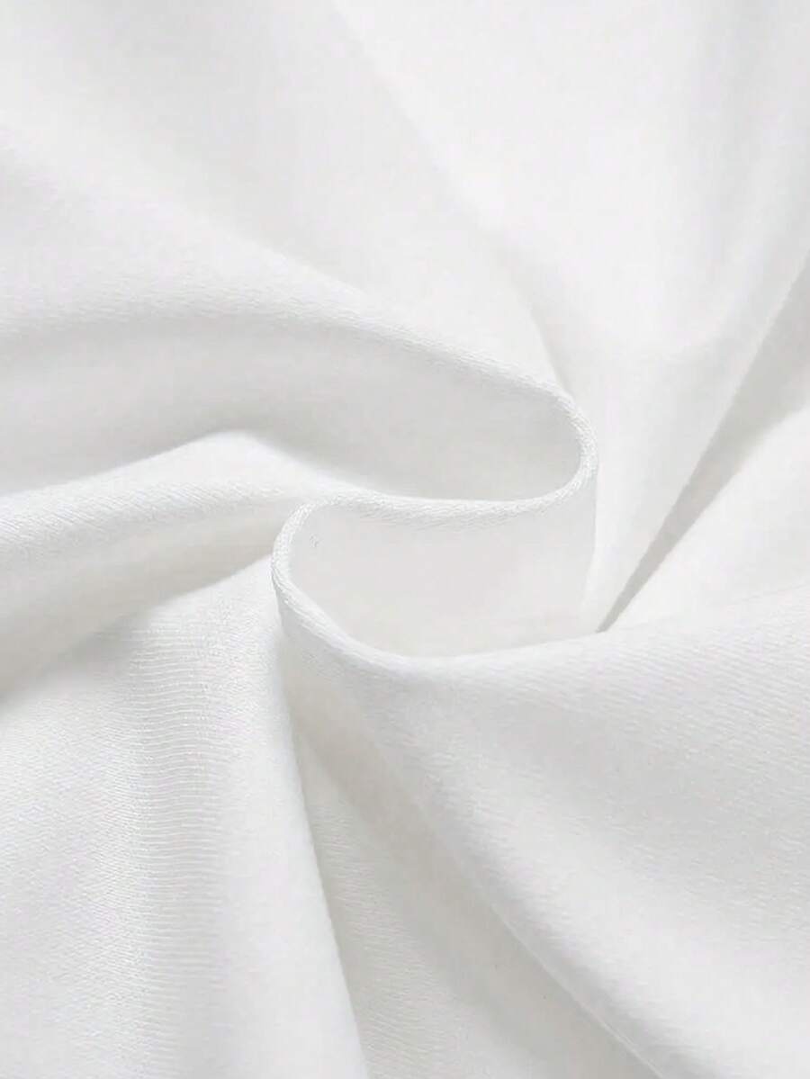 Close-up of white matte knit T-shirt fabric with soft folds and fine texture