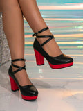 Front-side view of black glitter platform heels with red block heels and crossed straps