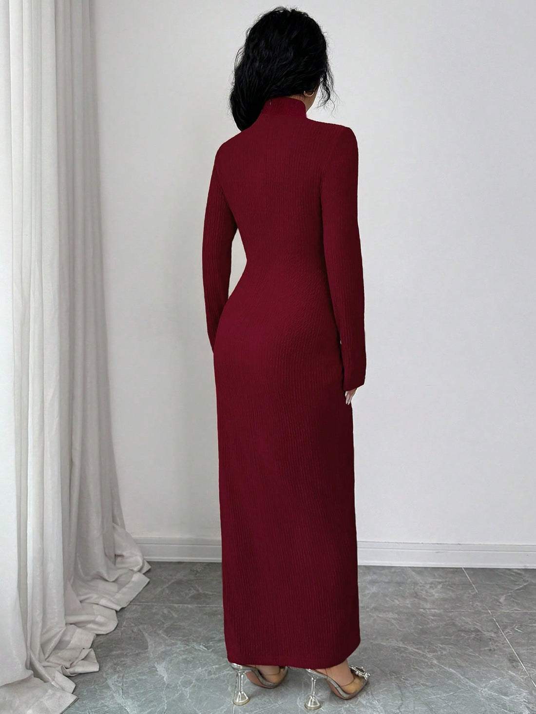 Wrap yourself in sophisticated style with this stunning burgundy knitted dress that's equal parts chic and cozy. The high neckline frames your face beautifully while the asymmetrical twisted design adds an unexpected twist—literally! Perfect for holiday parties, winter gatherings, or any occasion where you want to turn heads. The rich burgundy hue flatters every skin tone and pairs effortlessly with your favorite boots and accessories. Whether you're sipping cocoa at a festive bash or making an entrance at 