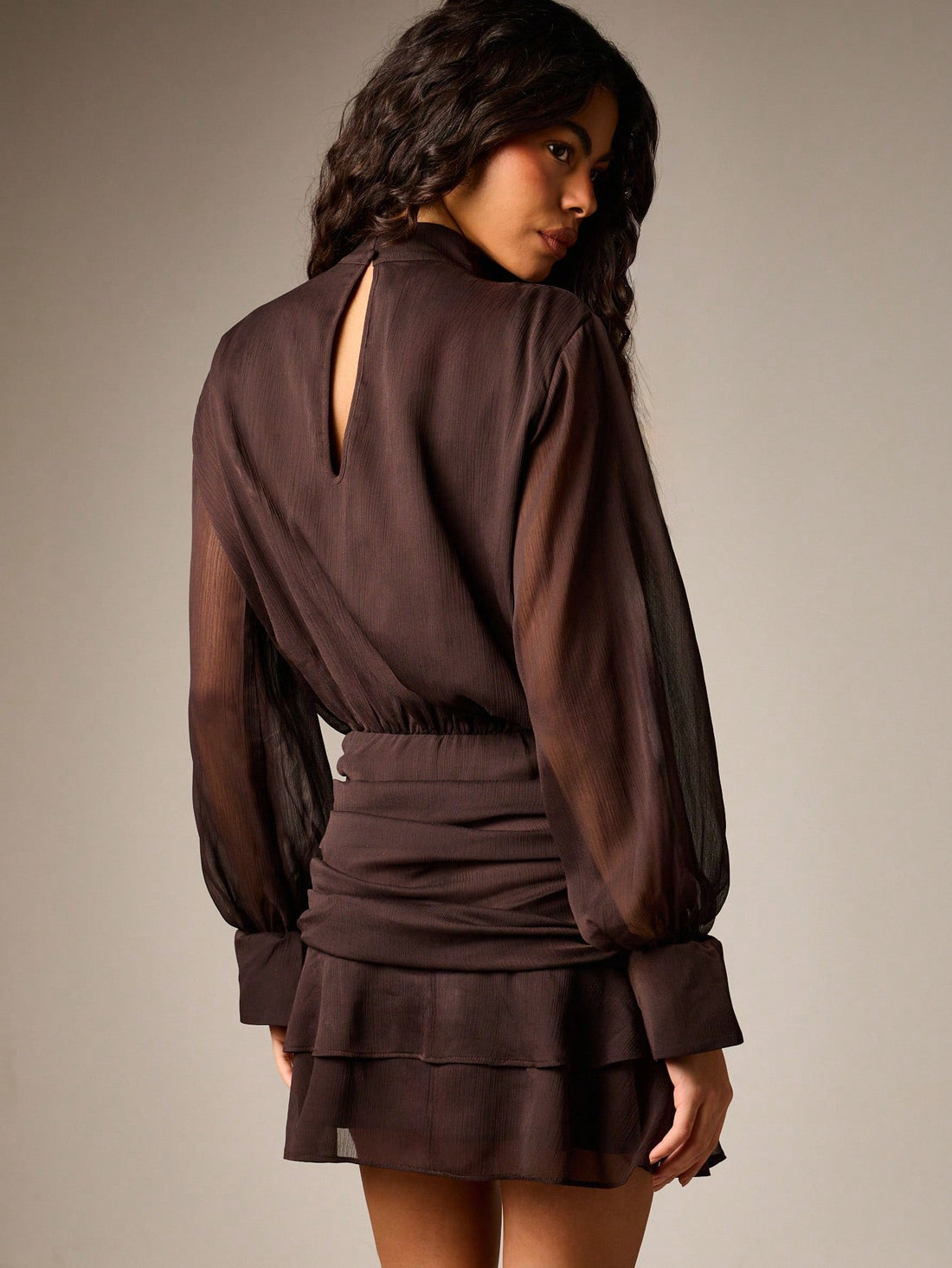 Turn heads at your next cocktail soirée in this chic ruched turtleneck mini dress. The fitted turtleneck hugs your silhouette while the playful ruffle skirt adds movement and flair—perfect for dancing the night away. Crafted for fall and winter gatherings, this dress transitions effortlessly from dinner to drinks. The ruching detail flatters your figure while the mini length shows off your style. Whether you're hitting a holiday party or weekend celebration, this is the dress that makes you feel confident a