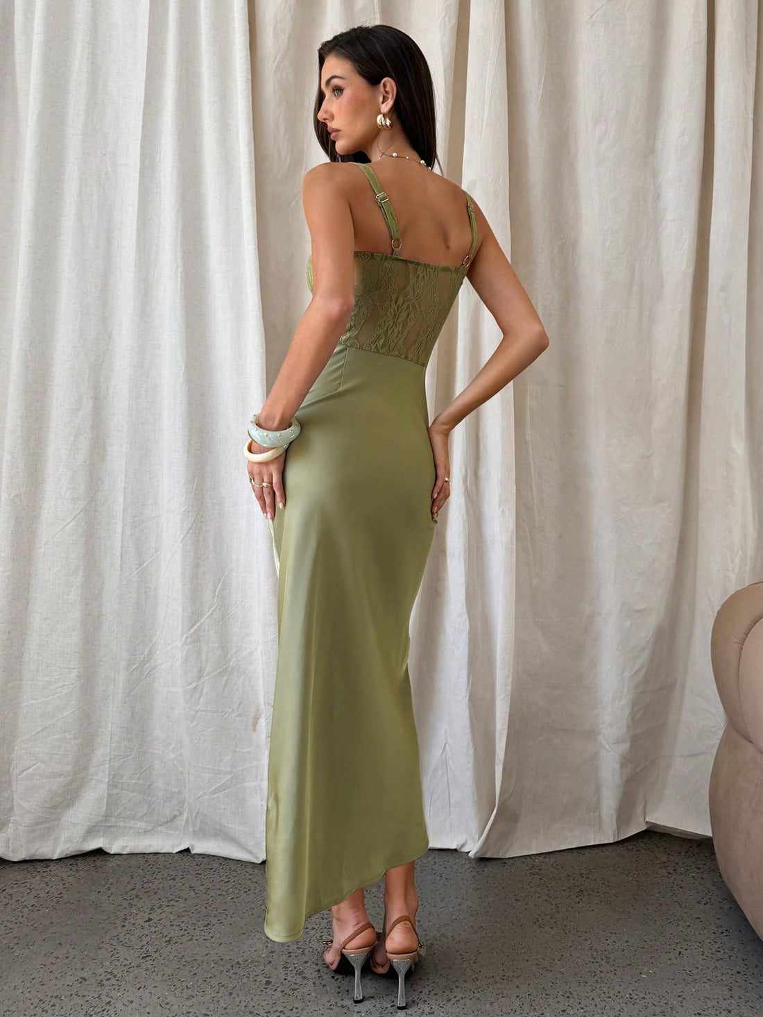 Elevate your seasonal style with this stunning olive green satin and lace patchwork dress—the perfect companion for autumn and winter celebrations. The luxurious satin base pairs beautifully with delicate lace accents, creating an eye-catching patchwork design that feels both sophisticated and effortlessly chic. Whether you're heading to a festive party or a romantic date night, this dress delivers elegance with a playful twist. The rich olive tone flatters all skin tones while the mixed textures add dimens