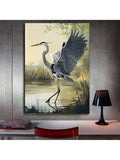Heron canvas wall art on concrete wall above desk