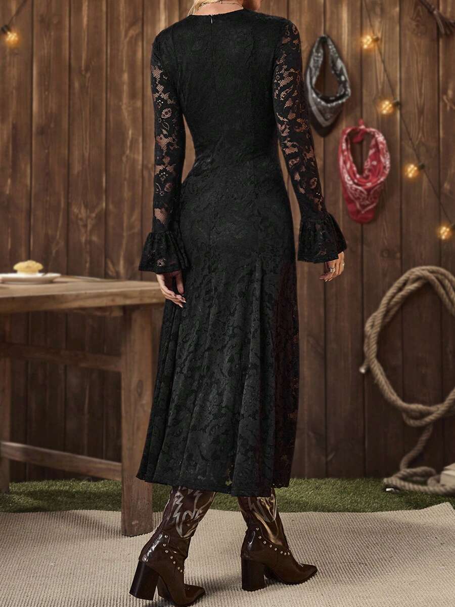 Detail view of flared hem and fitted waist on lace dress