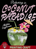 Close-up of Coconut Paradise tropical drink and Malibu California T-shirt artwork