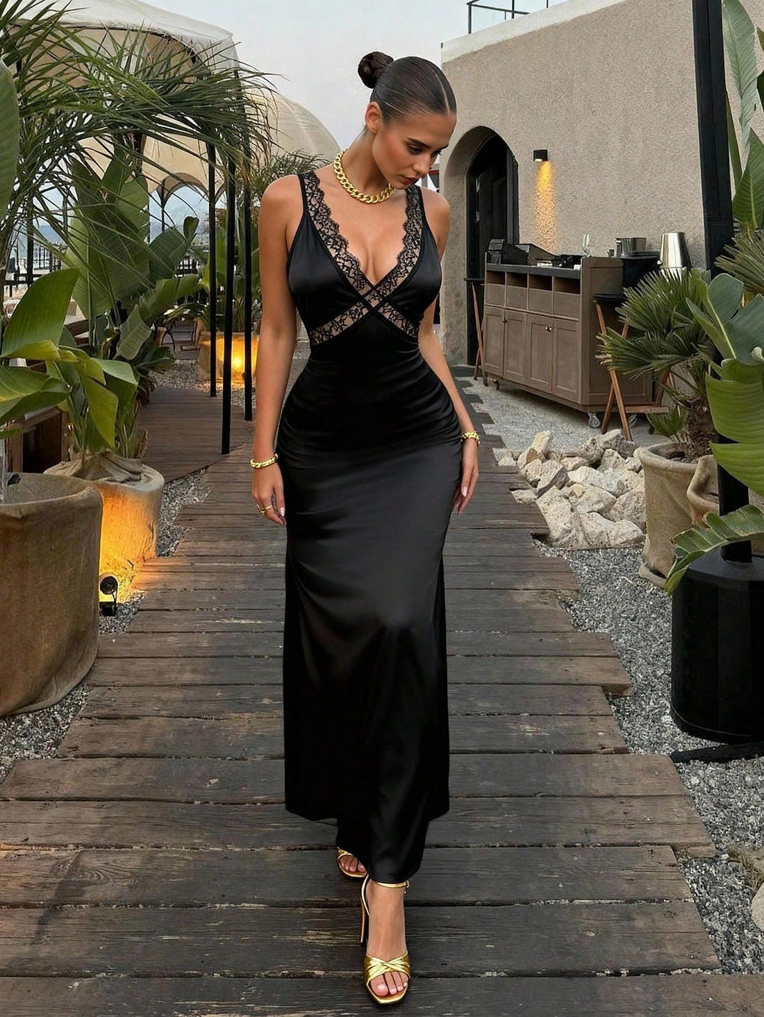 Slip into sophistication with this stunning black lace satin cami maxi dress that's basically a standing ovation waiting to happen. The deep V neckline adds just the right amount of allure, while delicate lace detailing keeps things classy and chic. Whether you're hitting the dance floor or turning heads at an evening soirée, this dress delivers that perfect blend of elegance and edge. The flowing maxi silhouette flatters every frame, making you feel like the main character in your own fabulous story. Dress