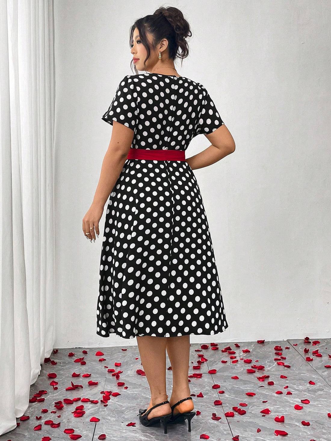 Step into the spotlight in this charming plus-size polka dot dress that blends vintage allure with modern elegance. The cinched waist creates a flattering silhouette that celebrates your curves, while classic polka dots add a playful, timeless touch. Perfect for parties, date nights, or any occasion calling for a dash of retro-inspired style. This dress proves that fashion-forward doesn't mean compromising on comfort or confidence. Twirl, dance, and shine in a piece designed to make you feel absolutely fabu