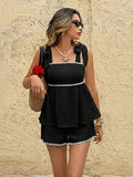 Front view of black cami and shorts set with white scalloped trim