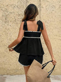 Back view of black tie-strap cami and matching mini shorts