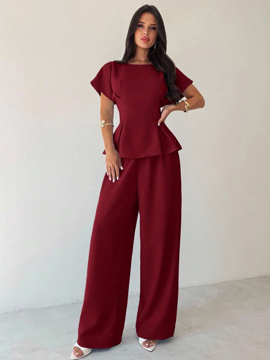 Elevate your wardrobe with this sophisticated 2-piece outfit set designed for the modern woman. Featuring an elegant burgundy blouse with distinctive batwing sleeves and a relaxed round neckline, paired with tailored long pants, this set effortlessly transitions from office meetings to weekend getaways. The loose-fitting silhouette offers comfort without compromising style, while the premium blend of 94% polyester and 6% elastane ensures durability and a refined drape. 