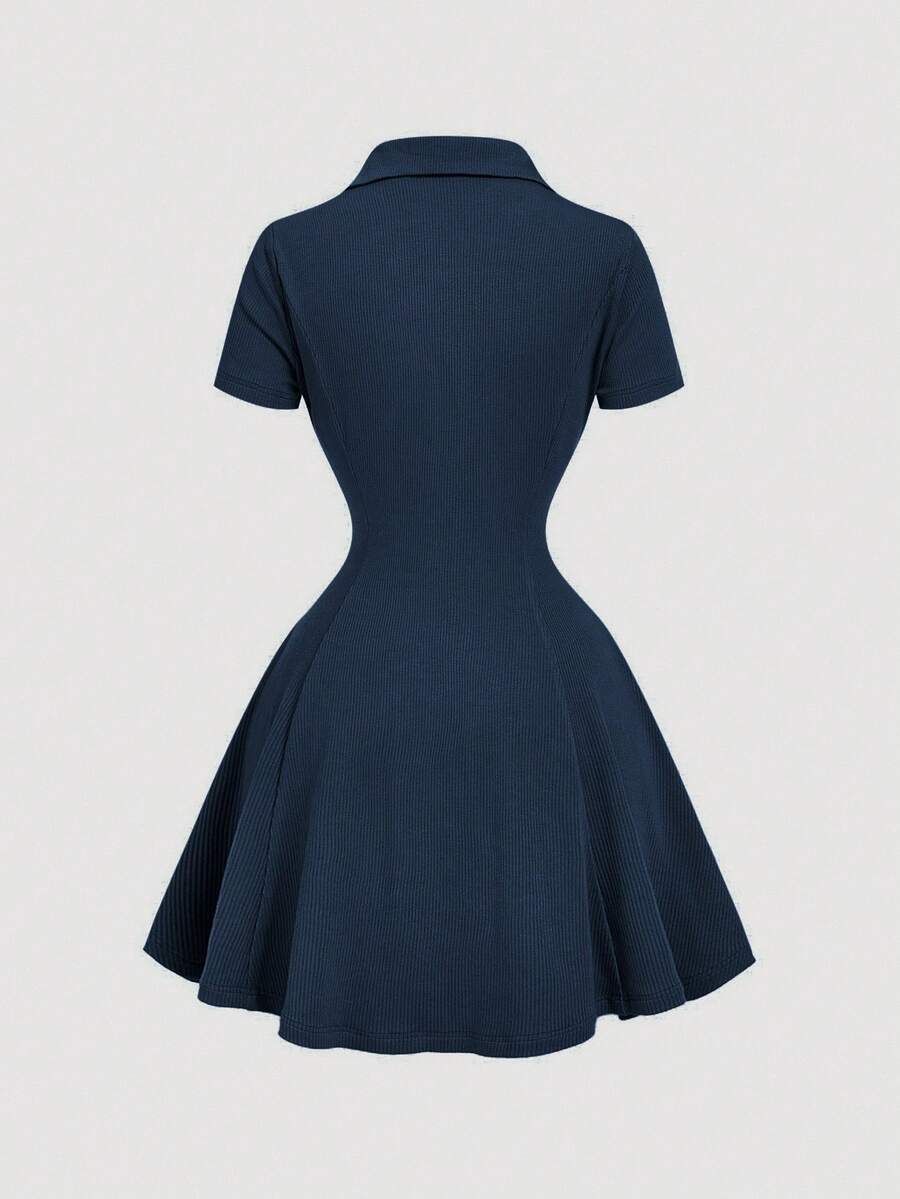 Front view of navy blue rib-knit polo mini dress with flared A-line hem