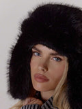Close up of black faux fur trapper hat showing dense soft texture
