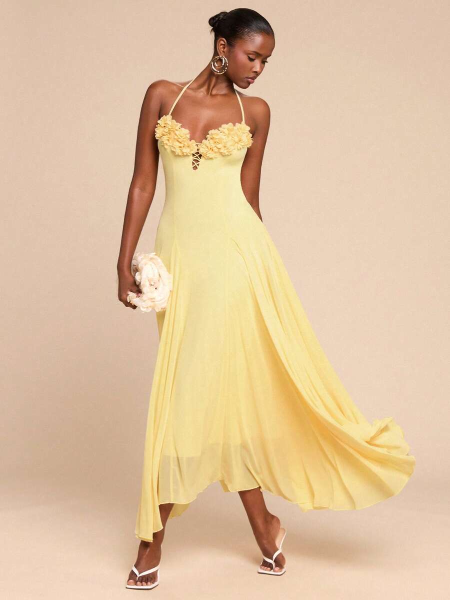Pale yellow floral halter maxi dress with plunging neckline and swinging sheer skirt