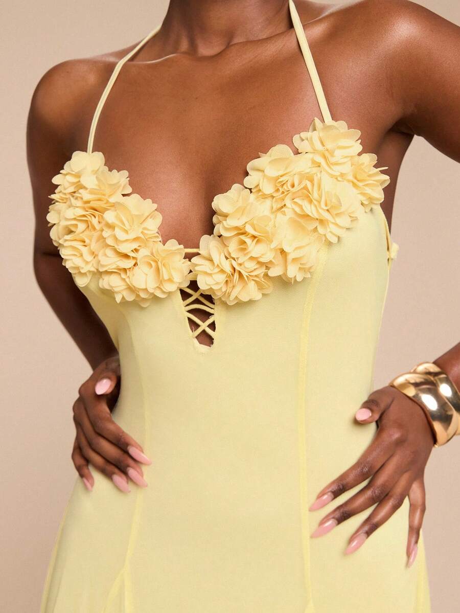 Close-up pale yellow halter dress with layered 3D flowers lace-up cutout and gold cuff