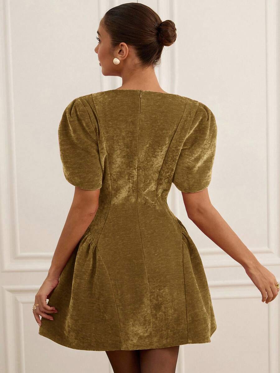 Elevate your wardrobe with this stunning Tulip 3D Graphic Peplum Mini Dress. Featuring a flattering high-waisted A-line silhouette with eye-catching peplum detailing, this dress combines elegance with modern style. The short puff sleeves and round neckline create a feminine, princess-inspired look perfect for night out occasions. Crafted from a durable polyester-elastane blend woven fabric, this olive green dress offers a regular fit with a flared hem. The convenient front zipper makes dressing effortless. 