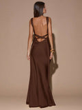 Close-up back view of ivory sleeveless deep V-neck maxi dress with crossed open back, shown for wedding and evening wear